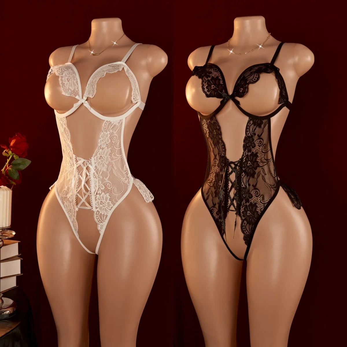 White and black floral lace open-cup bodysuits with lace-up detailing displayed side by side on mannequins